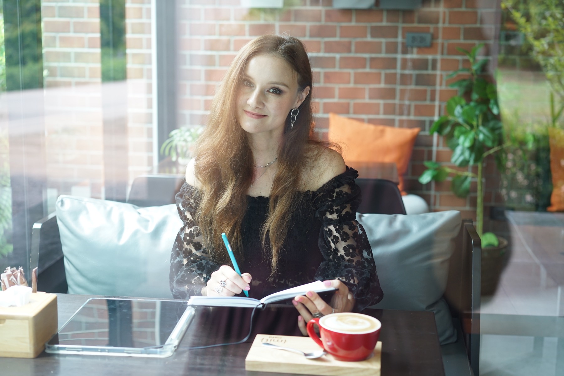 Alexandra writing in a notebook